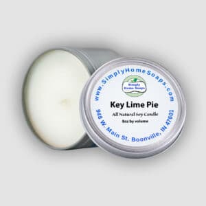 A candle tin on its side with an open lid - Key Lime Pie scented